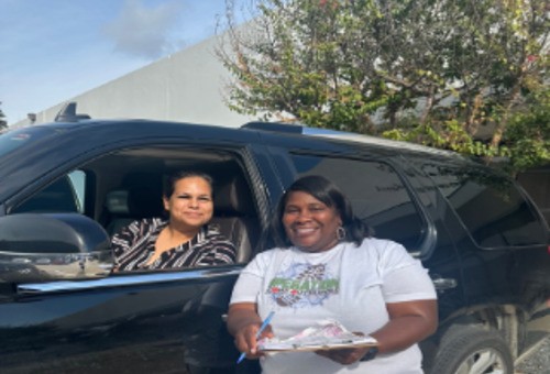 Volunteer serving a neighbor at a car